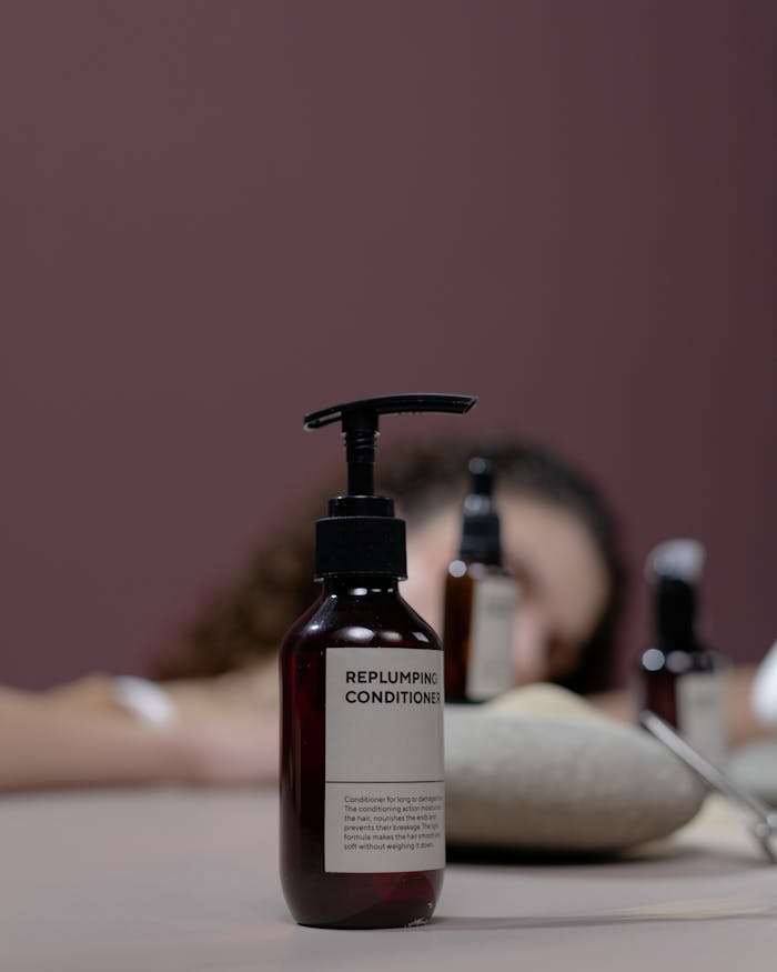 Elegant studio shot of an organic replumping conditioner with focus on the bottle.